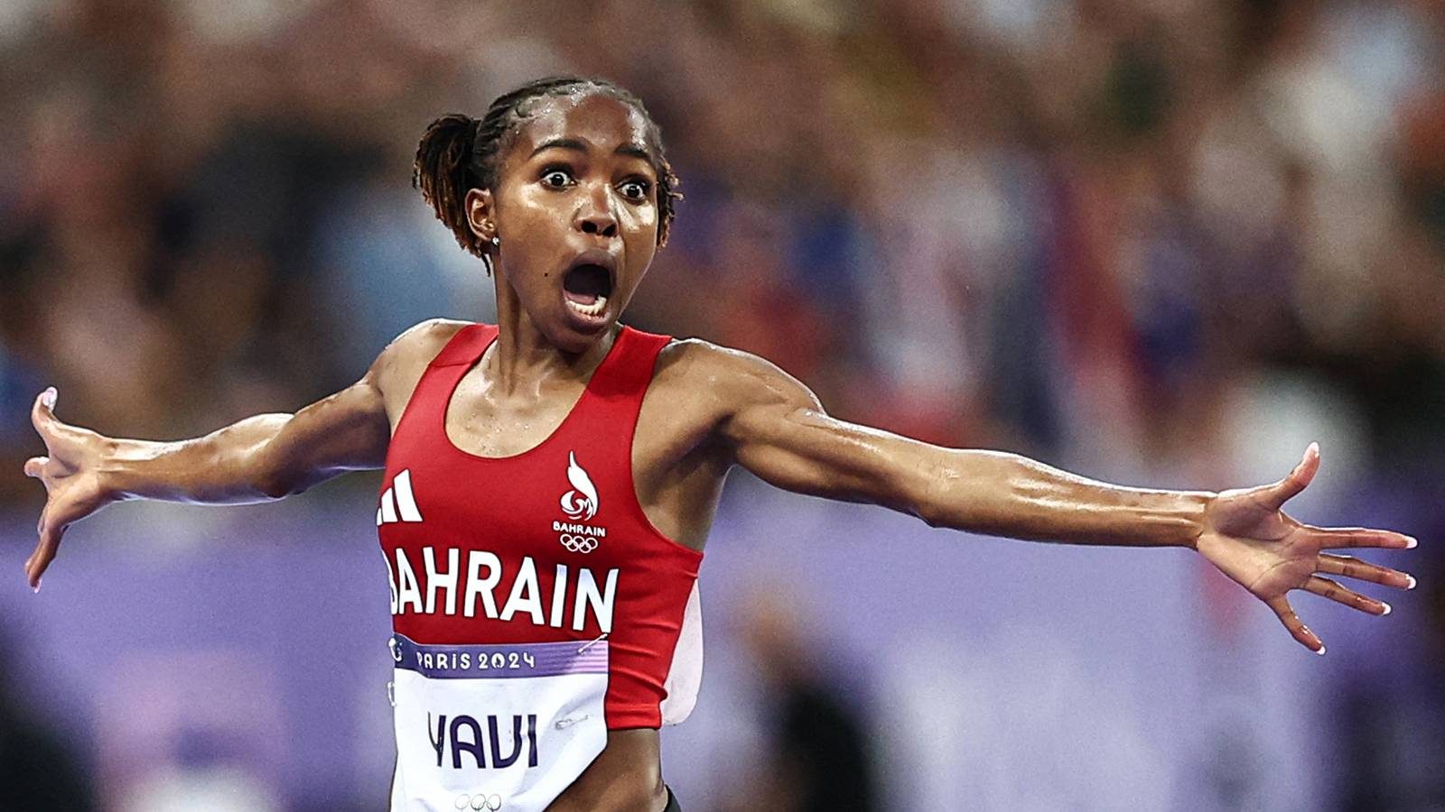Bahrain's Winfred Mutile Yavi celebrates winning the women's 3000m steeplechase final of the athletics event at the Paris 2024 Olympic Games at Stade de France in Saint-Denis, north of Paris, on August 6, 2024. (Photo by Anne-Christine POUJOULAT / AFP)