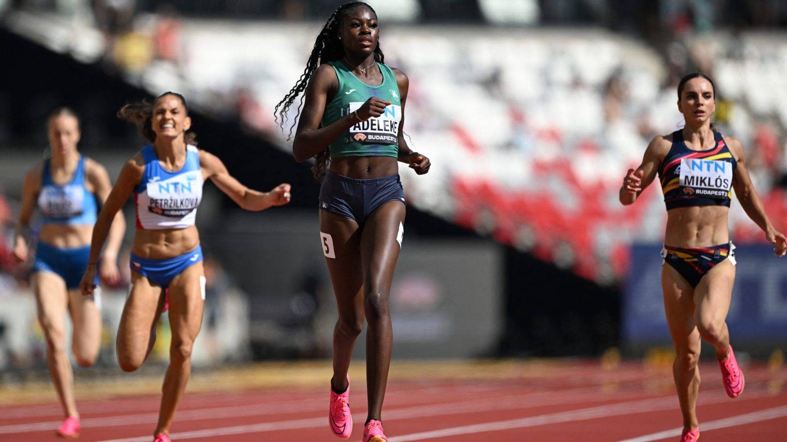 Ireland's Rhasidat Adeleke, Romania's Andrea Miklos, and Czech Republic's Tereza Petrzilkova cross the finish line in the women's 400m heats during the World Athletics Championships at the National Athletics Centre in Budapest on August 20, 2023. 
Jewel SAMAD / AFP